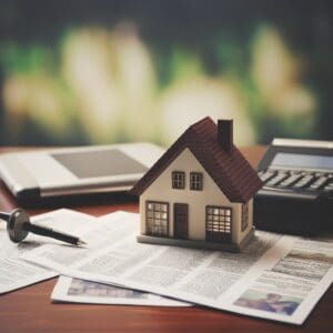 Press release on a stack of newspapers with a house on top