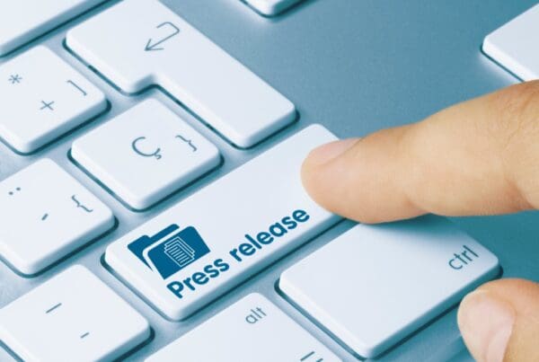 Finger pressing a button that says press release
