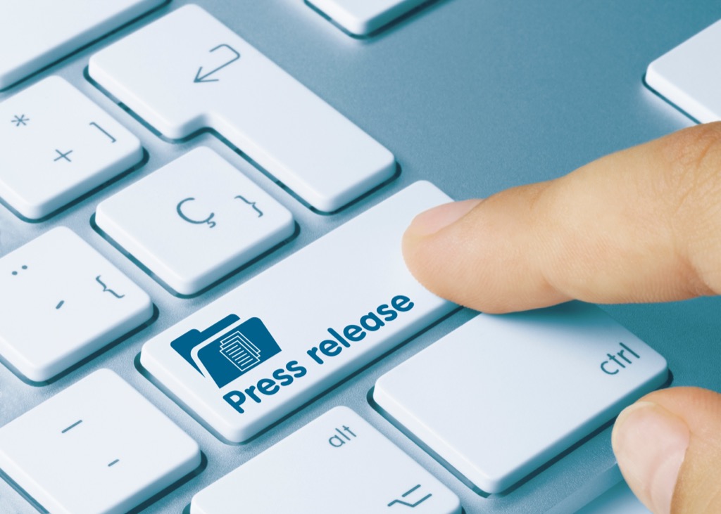 Finger pressing a button that says press release